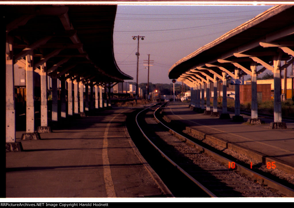 Action at Seaboard Station! A southbound pig train is headed to the platforms while a northbound pig train passes on the next track